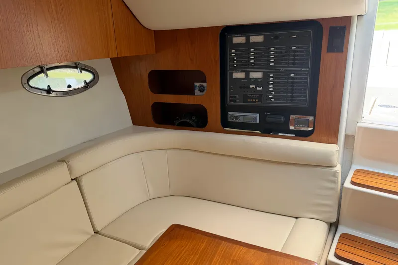Slide: The Image of Interior of 1994 Tiara Yachts 3100 Open, featuring wood accents and seating area. - 4