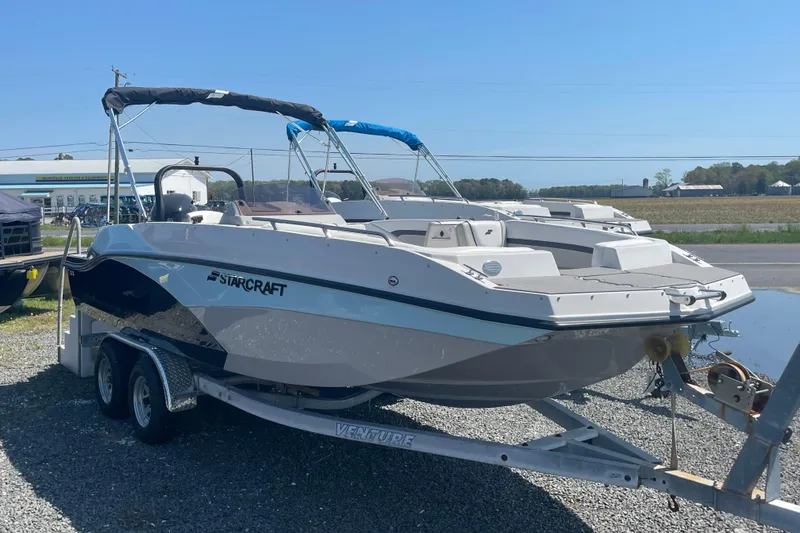The Image of 2026 Starcraft SVX 211 OB boat on trailer, parked outdoors. - 0