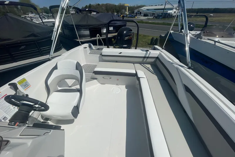 Slide: The Image of 2026 Starcraft SVX 211 OB boat interior with seating and steering wheel. - 10