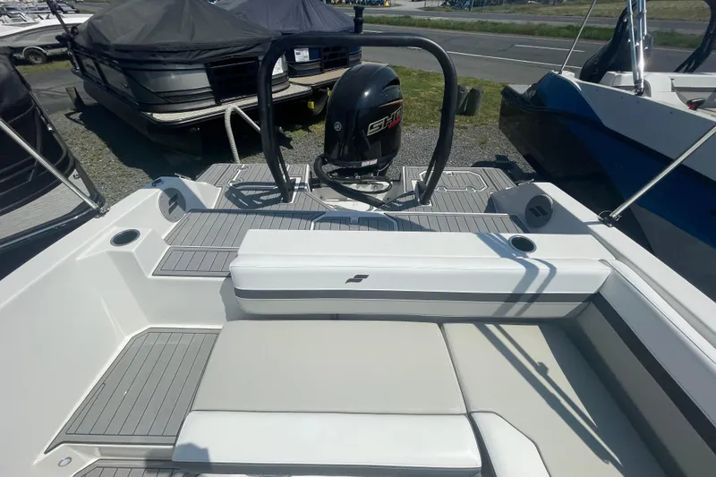 Slide: The Image of 2026 Starcraft SVX 211 OB boat interior with seating and outboard motor. - 14