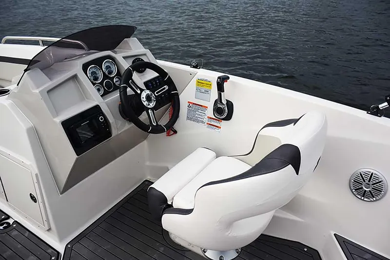 Slide: The Image of Manufacturer Provided Image: 2026 Starcraft SVX 211 OB boat cockpit with steering wheel and controls on water. - 17