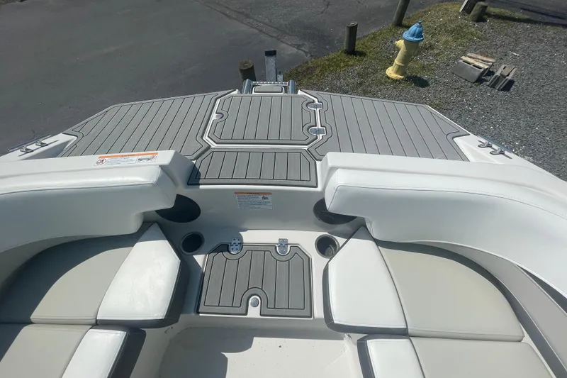 Slide: The Image of 2026 Starcraft SVX 211 OB boat interior with gray decking and white seating. - 20
