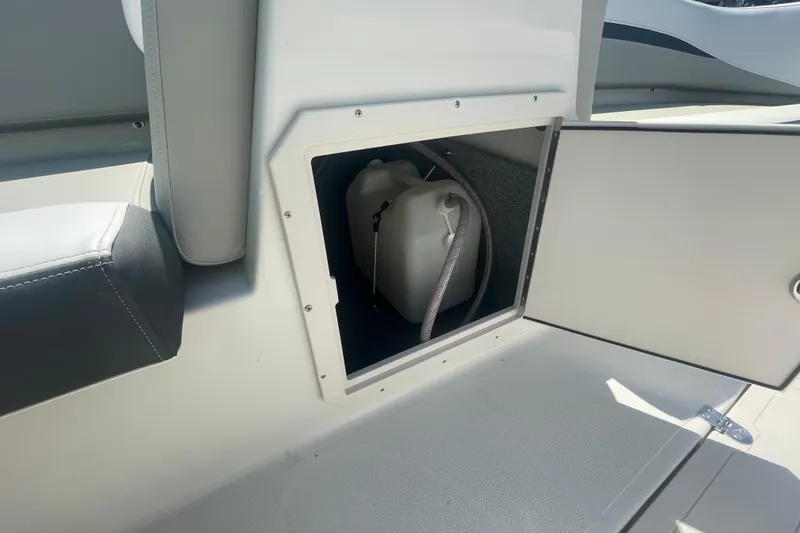 Slide: The Image of Storage compartment on 2026 Starcraft SVX 211 OB boat with a white container inside. - 3