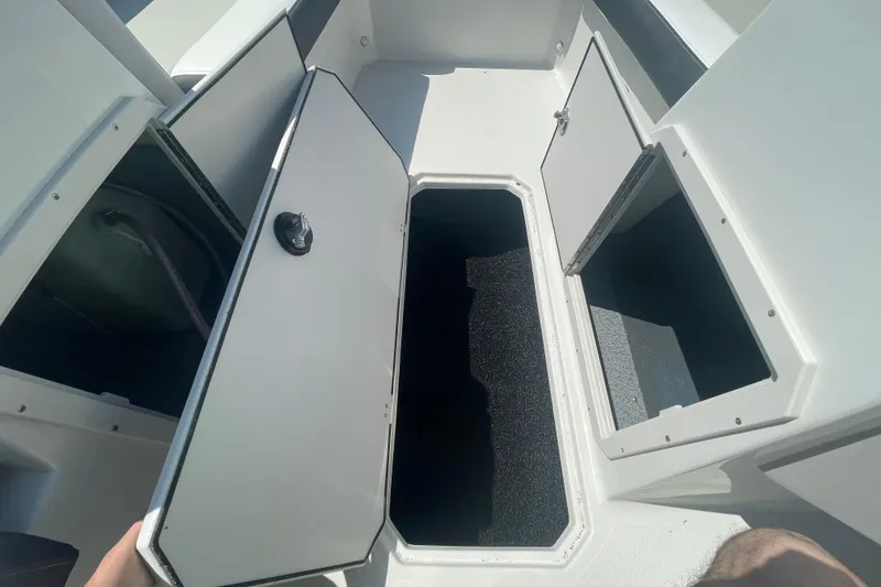 Slide: The Image of 2026 Starcraft SVX 211 OB boat storage compartments with open hatches, showcasing interior space. - 4
