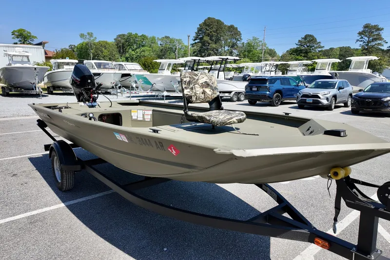 Slide: The Image of 2025 TRACKER BOATS 1654 MVX Sportsman on trailer in parking lot. - 10