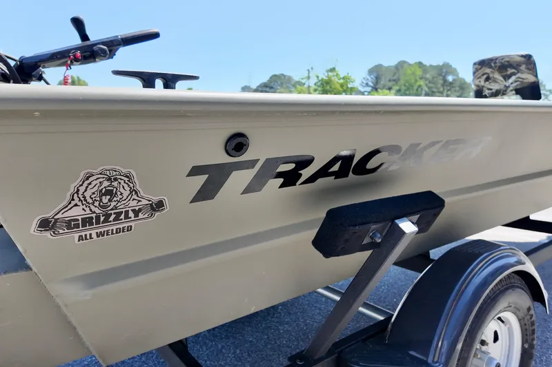 Slide: The Image of 2025 TRACKER BOATS 1654 MVX Sportsman, Grizzly all-welded logo, on trailer. - 3