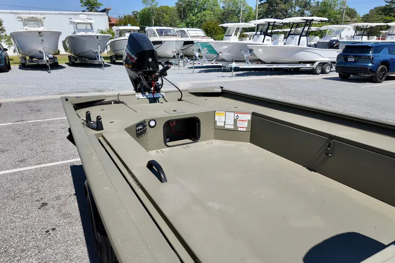 Slide: The Image of 2025 TRACKER BOATS 1654 MVX Sportsman in parking lot, surrounded by other boats. - 8