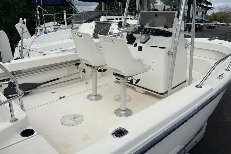 Slide: The Image of 1999 Boston Whaler Outrage 18 boat interior with dual seats and control console. - 7