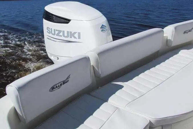Slide: The Image of Manufacturer Provided Image: 2025 Bulls Bay 230 Center Console boat with Suzuki outboard engine on calm water. - 5