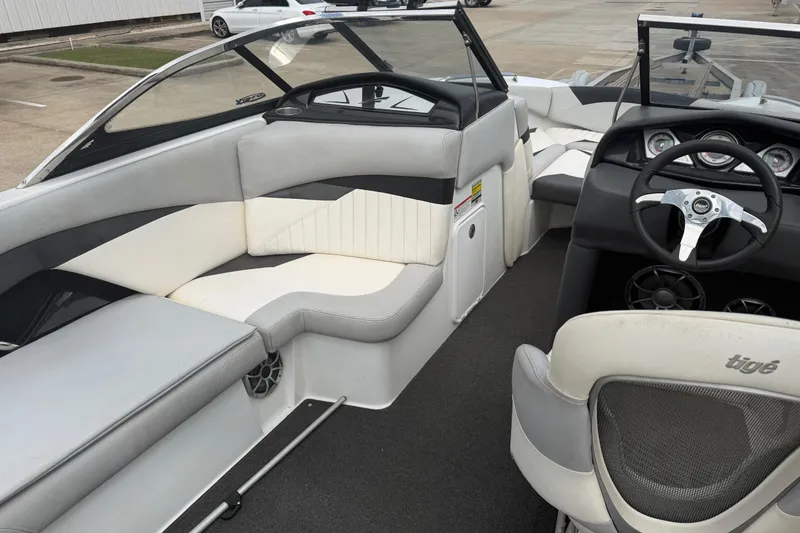 Slide: The Image of 2010 Tigé RZ2 boat interior with sleek seating and modern dashboard design. - 10