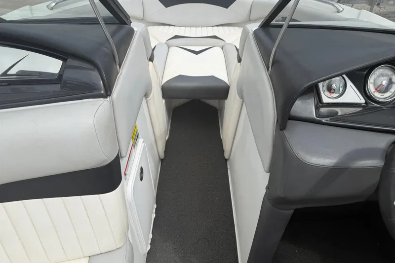 Slide: The Image of Interior view of 2010 Tigé RZ2 boat, featuring sleek seating and dashboard design. - 12