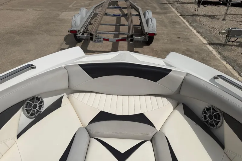 Slide: The Image of 2010 Tigé RZ2 boat interior with stylish seating and speakers, parked on a trailer. - 15