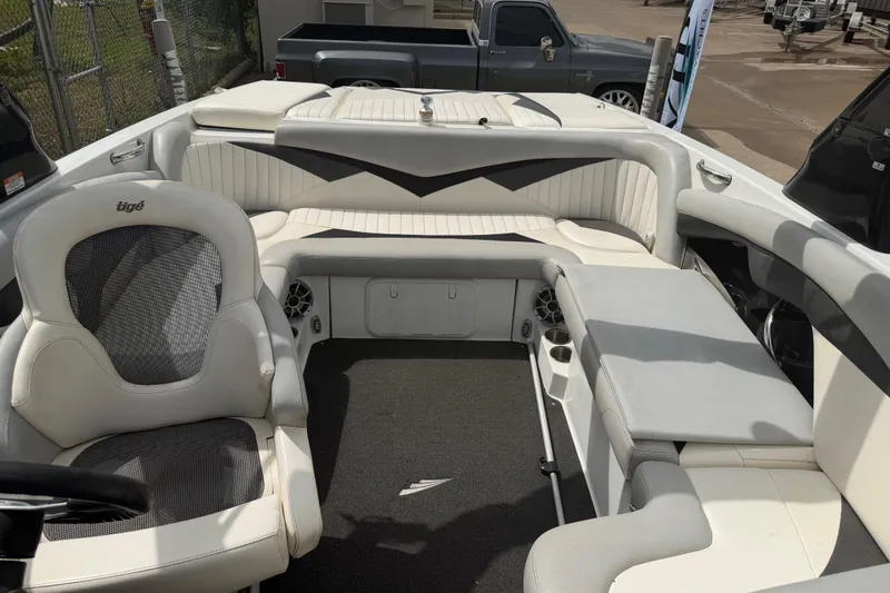 Slide: The Image of Interior of a 2010 Tigé RZ2 boat with white seating and modern design. - 17