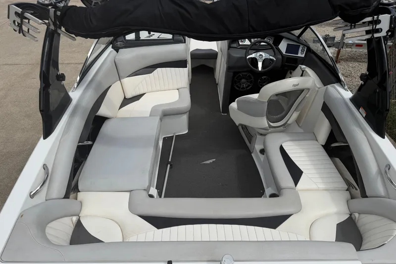 Slide: The Image of Interior of a 2010 Tigé RZ2 boat with white and gray seating. - 23