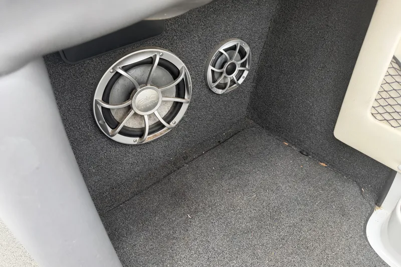 Slide: The Image of 2010 Tigé RZ2 boat interior with dual speakers on carpeted surface. - 25