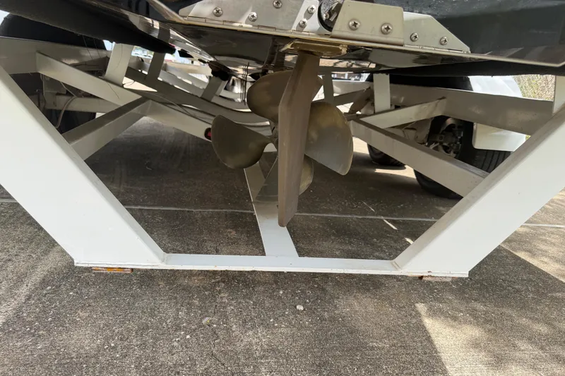 Slide: The Image of 2010 Tigé RZ2 boat propeller on a trailer, viewed from underneath. - 28