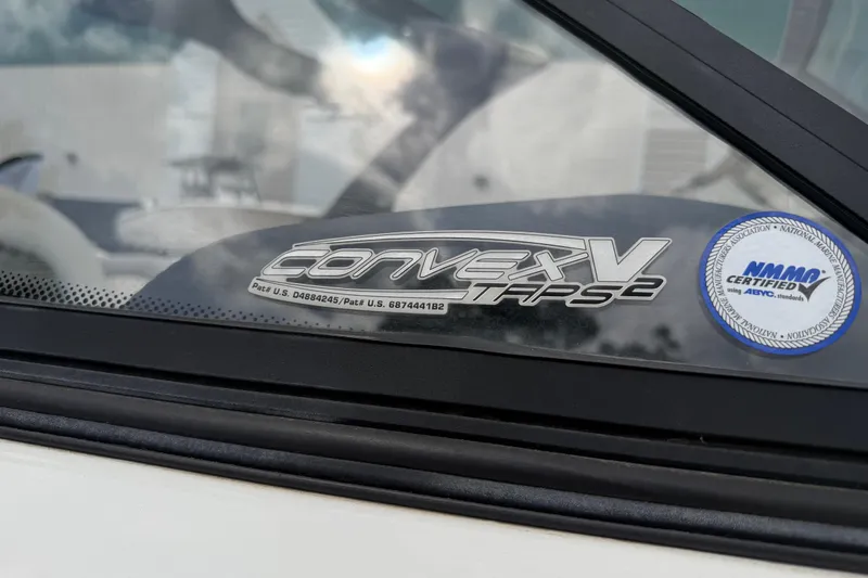 Slide: The Image of 2010 Tigé RZ2 boat window with Convex V TAPS2 and NMMA certification sticker. - 30