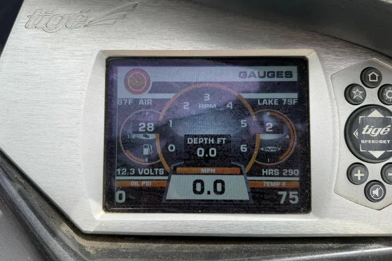 Slide: The Image of Dashboard of a 2010 Tigé RZ2 boat displaying gauges and controls. - 34