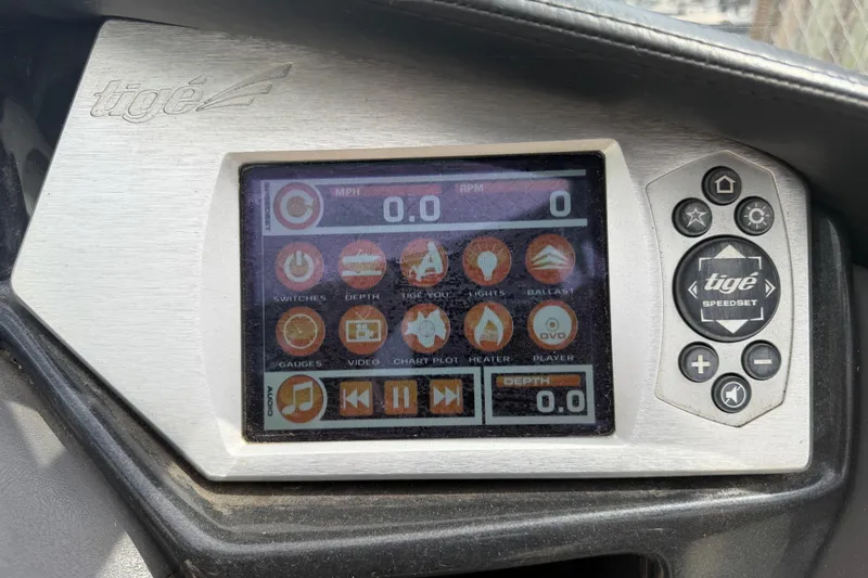 Slide: The Image of 2010 Tigé RZ2 boat dashboard with touchscreen controls and speed settings. - 35