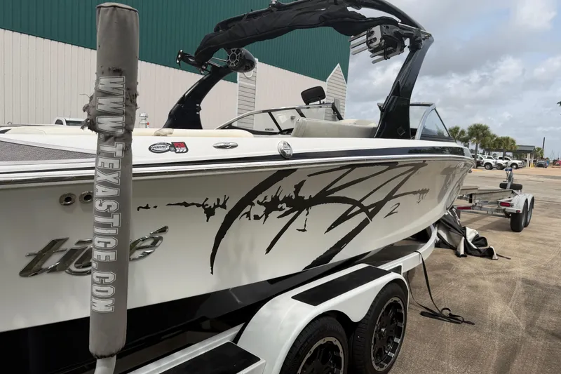 Slide: The Image of 2010 Tigé RZ2 boat on trailer, featuring sleek design and custom graphics. - 4