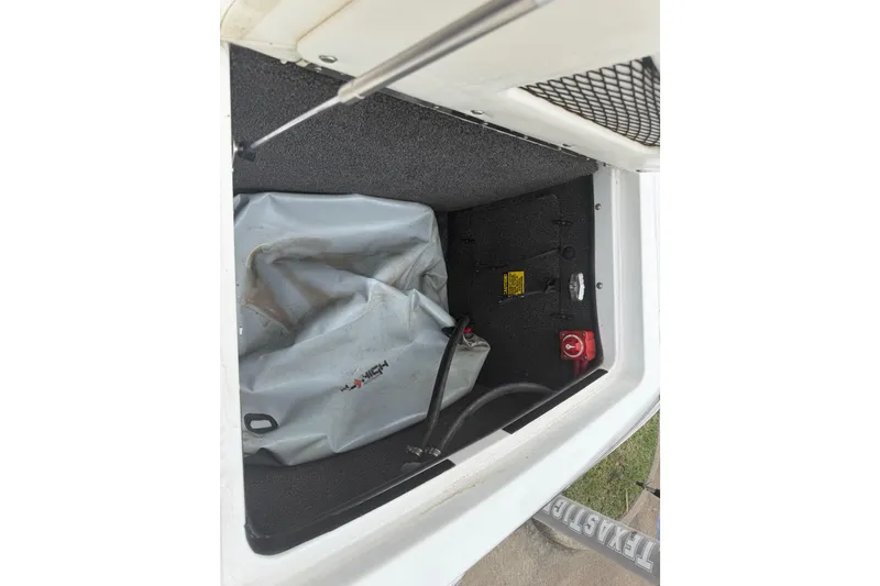 Slide: The Image of 2010 Tigé RZ2 boat storage compartment with equipment and wiring. - 7