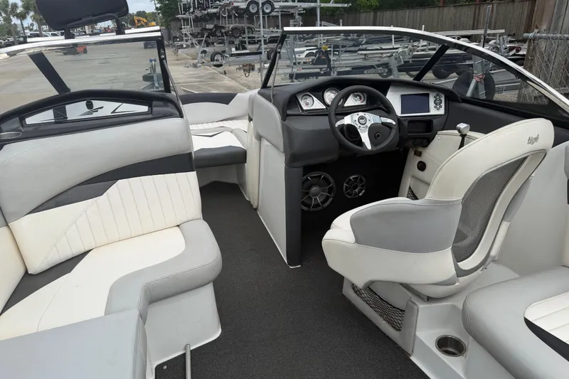 Slide: The Image of 2010 Tigé RZ2 boat interior with sleek seating and modern dashboard design. - 9