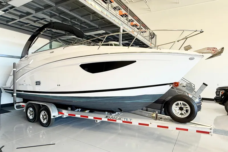 The Image of 2021 Regal 26 Express boat on trailer in indoor storage facility. - 0