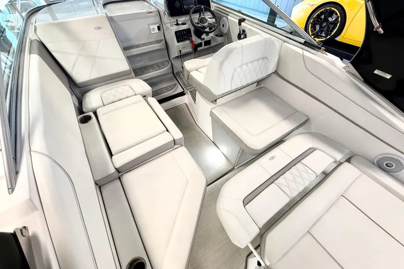 Slide: The Image of 2021 Regal 26 Express boat interior with luxurious white seating and modern dashboard. - 10