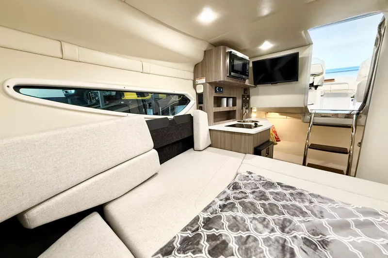Slide: The Image of Interior of 2021 Regal 26 Express boat with modern amenities and cozy seating. - 19