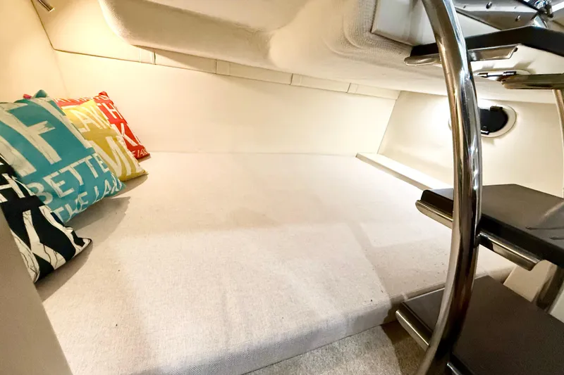 Slide: The Image of Interior cabin of 2021 Regal 26 Express boat with colorful pillows and sleek stairs. - 20
