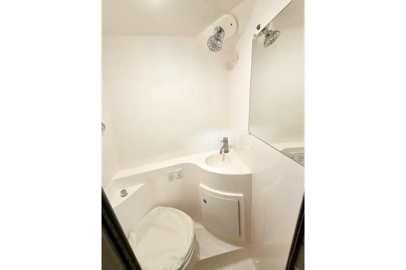 Slide: The Image of Compact bathroom in 2021 Regal 26 Express boat with shower and sink. - 27