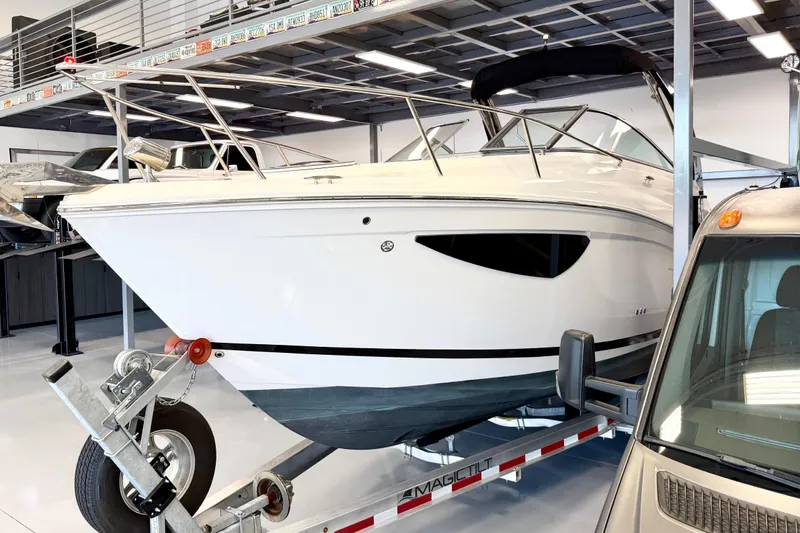 Slide: The Image of 2021 Regal 26 Express boat on trailer in showroom setting. - 3