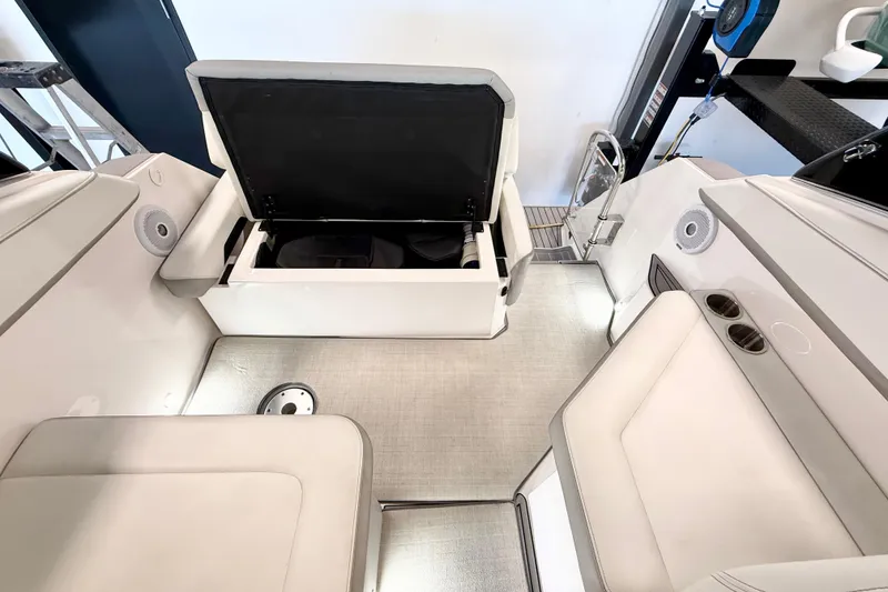 Slide: The Image of 2021 Regal 26 Express boat interior with open storage compartment and seating area. - 34