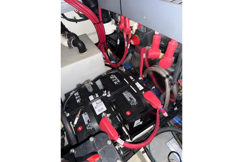 Slide: The Image of Battery compartment of a 2021 Regal 26 Express boat with red cables and connectors. - 42