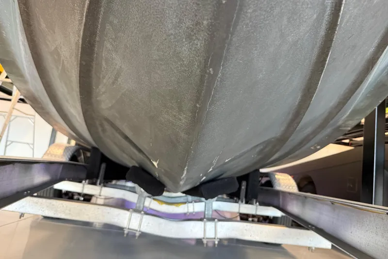 Slide: The Image of 2021 Regal 26 Express boat hull on trailer, close-up view. - 47