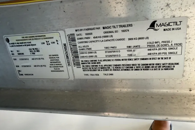 Slide: The Image of Label on Magic Tilt trailer, detailing tire and loading information, made in USA. - 48