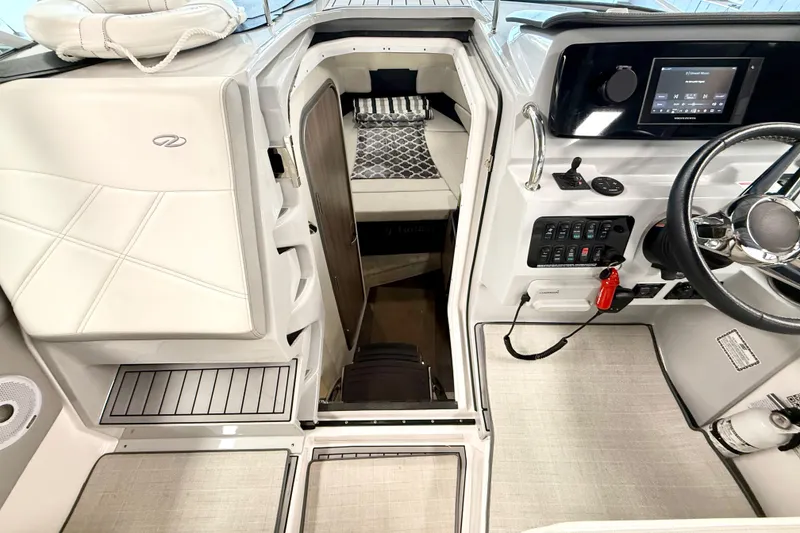 Slide: The Image of 2021 Regal 26 Express boat interior with helm, cabin entrance, and modern controls. - 5