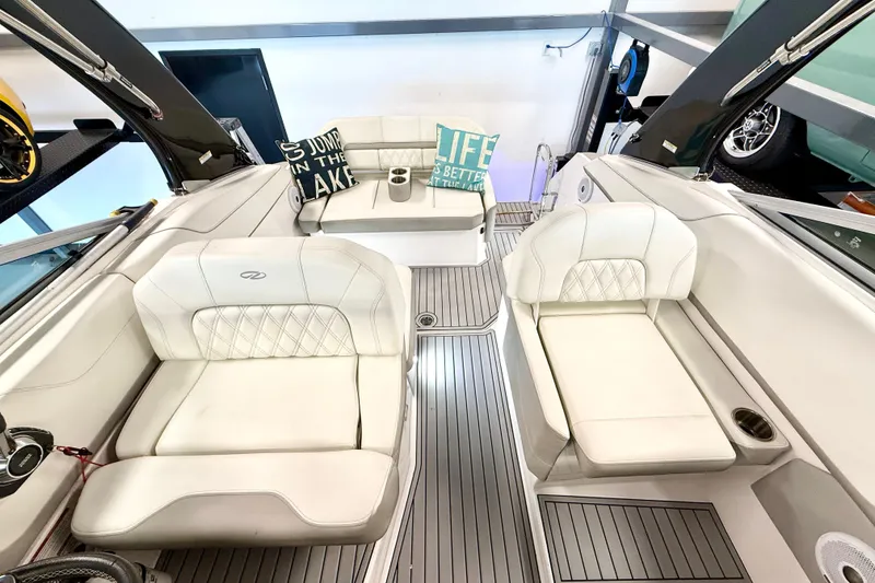 Slide: The Image of Interior of a 2021 Regal 26 Express boat with white seating and decorative pillows. - 7