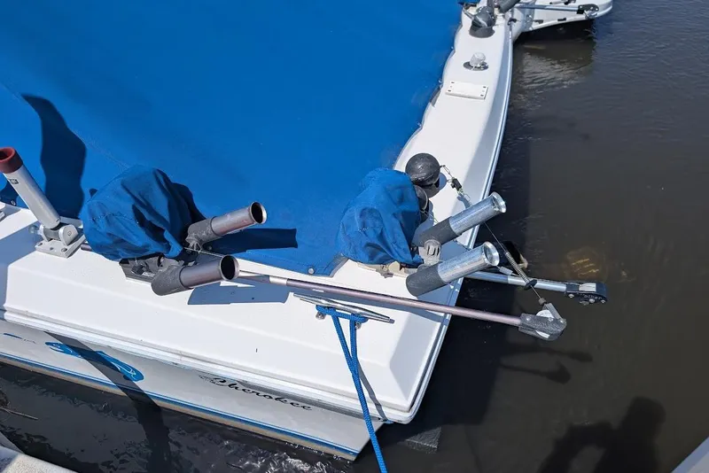Slide: The Image of 1998 Cherokee 270 Sportsman boat with blue cover and fishing rod holders. - 10