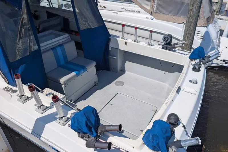 Slide: The Image of 1998 Cherokee 270 Sportsman boat with blue seating and fishing rod holders. - 14