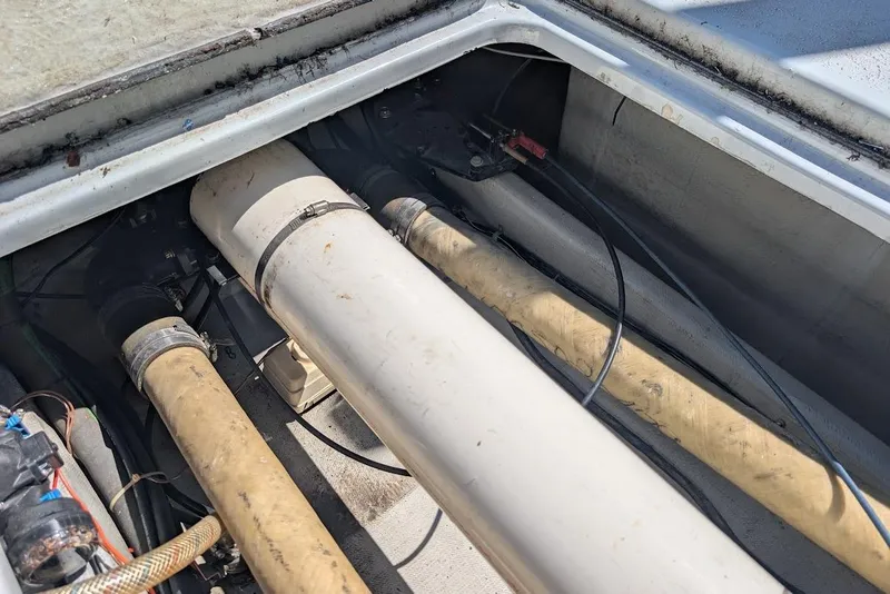 Slide: The Image of Engine compartment of a 1998 Cherokee 270 Sportsman boat, showing pipes and wiring. - 16