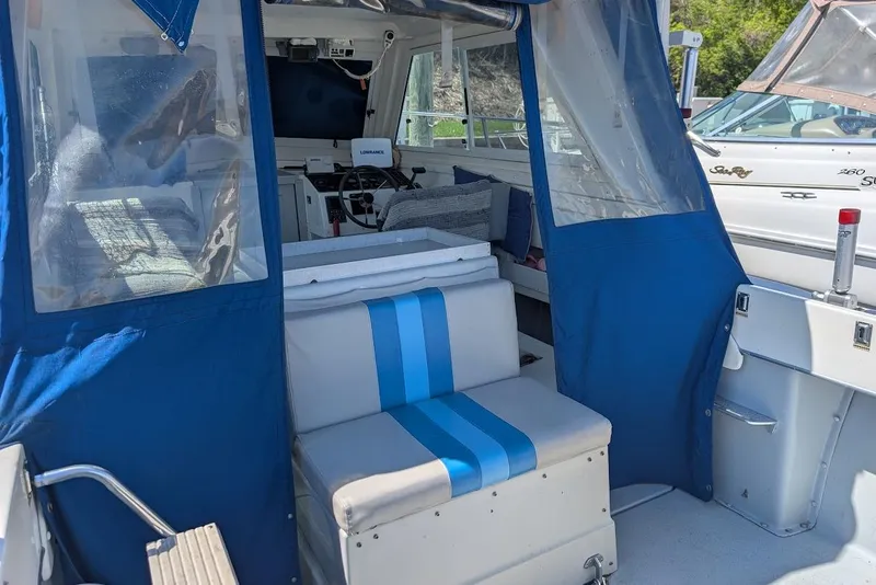 Slide: The Image of 1998 Cherokee 270 Sportsman boat interior with blue and white seating and navigation equipment. - 19