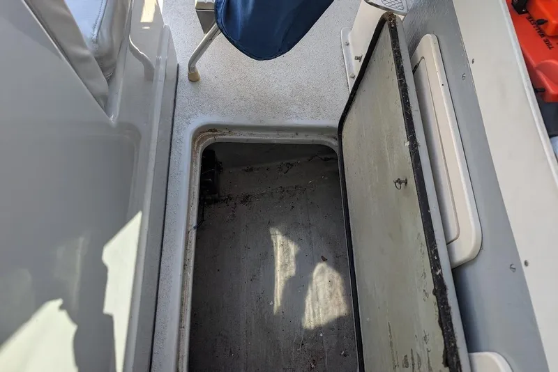 Slide: The Image of Open storage compartment on a 1998 Cherokee 270 Sportsman boat deck. - 20