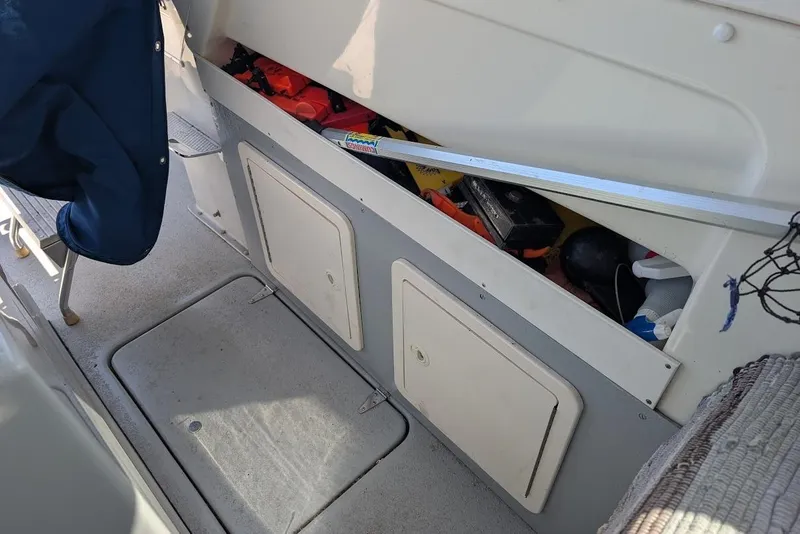 Slide: The Image of Interior view of a 1998 Cherokee 270 Sportsman boat showing storage compartments. - 21