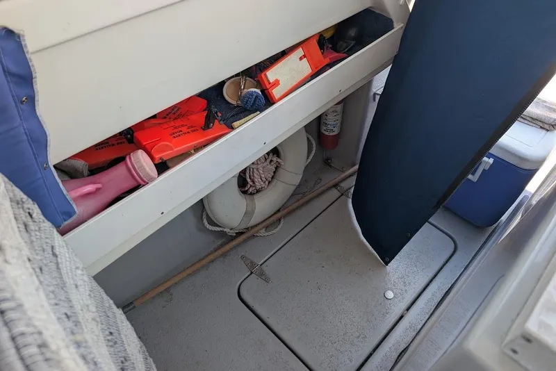 Slide: The Image of Interior of a 1998 Cherokee 270 Sportsman boat with safety equipment and storage. - 22