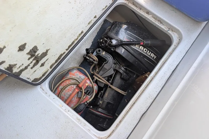 Slide: The Image of Compartment of 1998 Cherokee 270 Sportsman with Mercury outboard motor and fuel tank. - 23