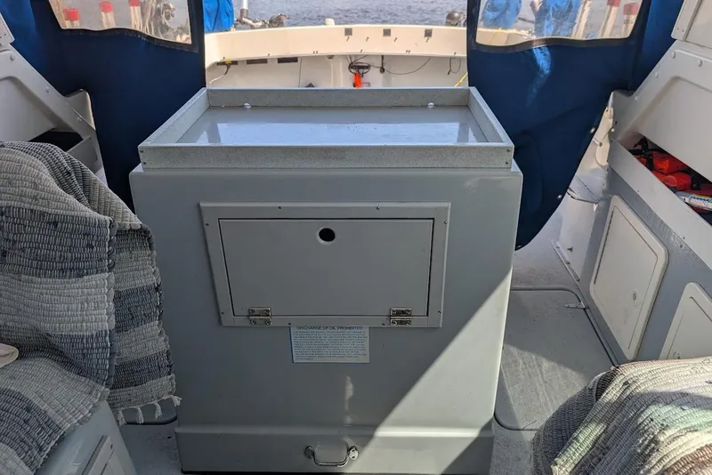 Slide: The Image of Interior of a 1998 Cherokee 270 Sportsman boat with storage compartment. - 24