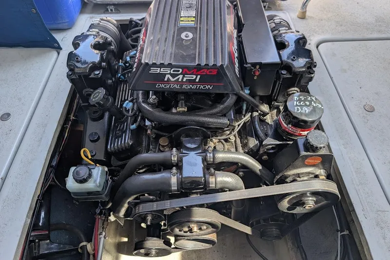 Slide: The Image of Engine of a 1998 Cherokee 270 Sportsman boat, featuring a 350 MAG MPI motor. - 27