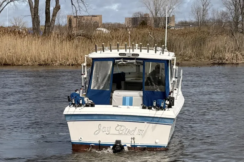 Slide: The Image of 1998 Cherokee 270 Sportsman boat named "Jay Bird III" on a river. - 3