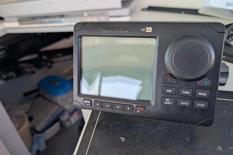 Slide: The Image of Simrad AP28 autopilot control on 1998 Cherokee 270 Sportsman boat dashboard. - 34
